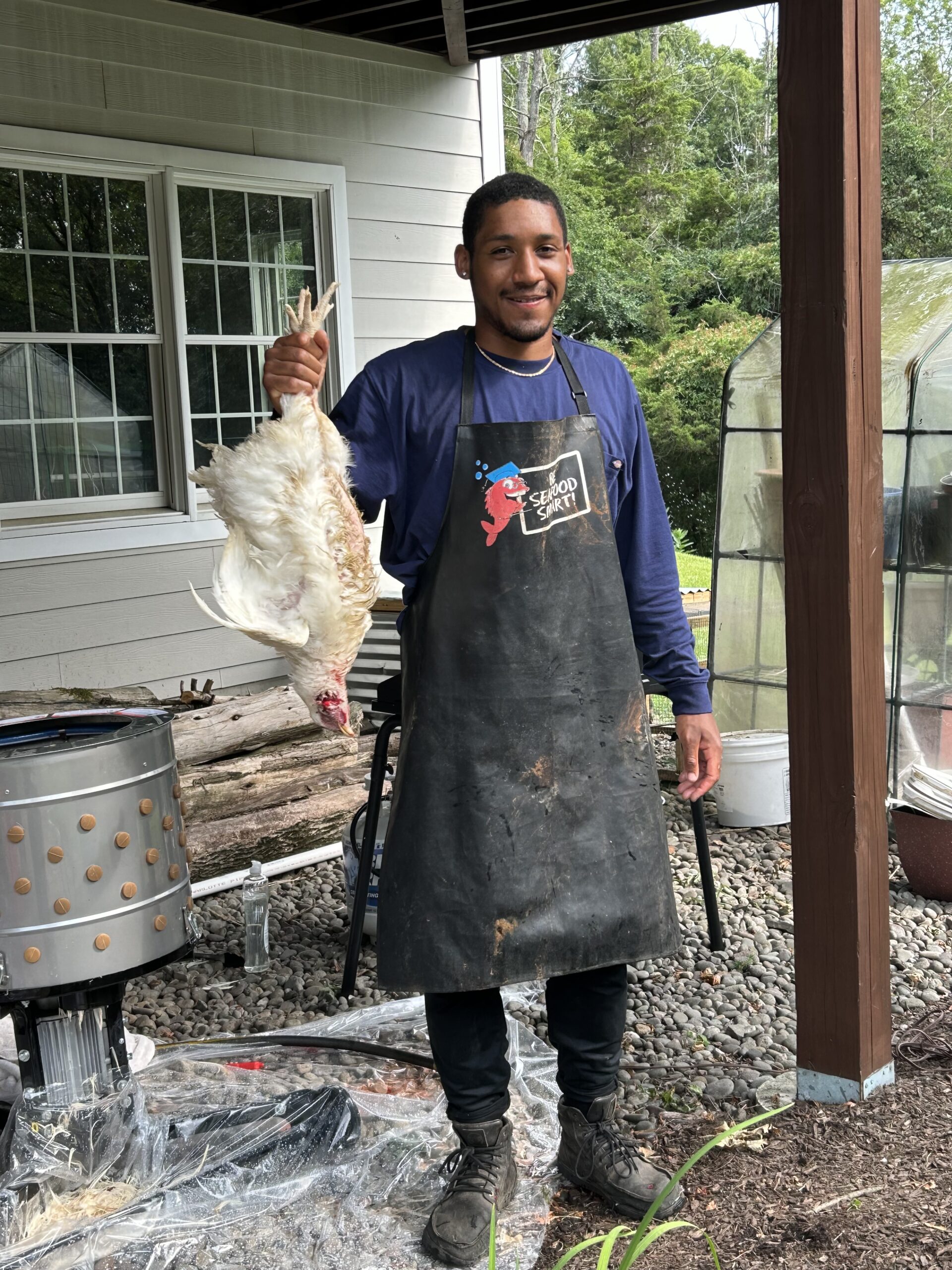 Koby Adjei holding a butchered chicken